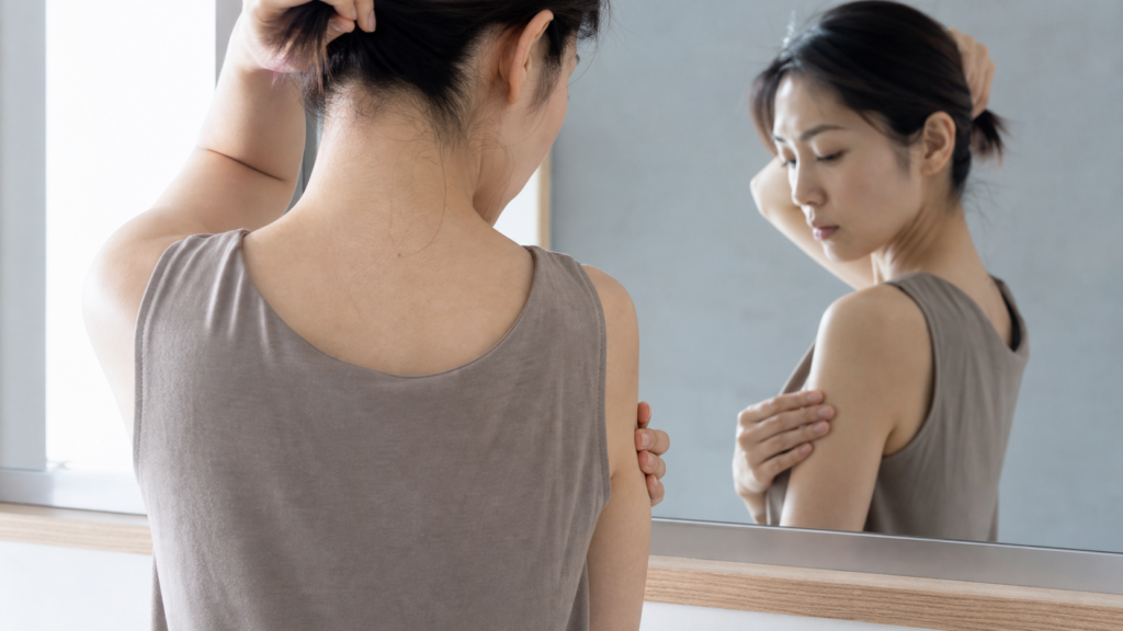 家庭用脱毛器による硬毛化に注意したいうなじ・肩・二の腕を鏡で確認する日本人女性